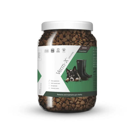 A clear plastic jar of verm-x original crunchies for dogs with natural active ingredients to control intestinal hygiene
