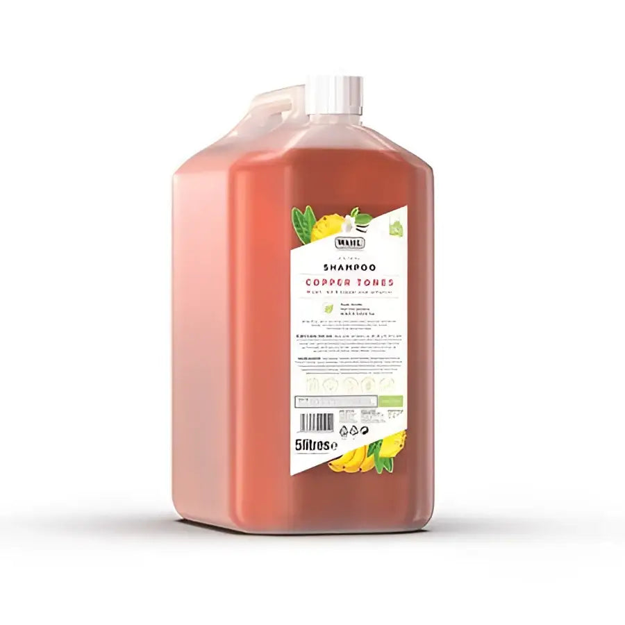 A 5 litre transparent plastic bottle of wahl copper tones shampoo with a white cap and lemon label a perfectly balanced formula