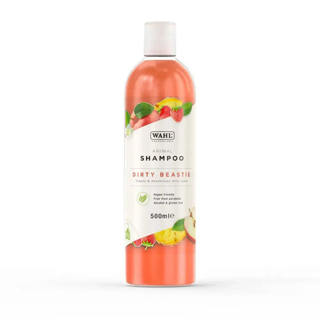 A transparent bottle of wahl dirty beastie shampoo with vibrant orange liquid and a perfectly balanced formula