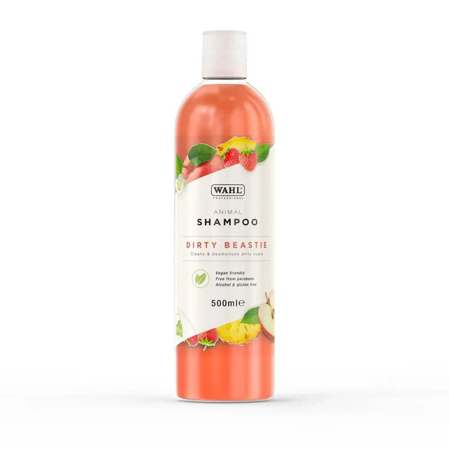 A transparent bottle of wahl dirty beastie shampoo with vibrant orange liquid and a perfectly balanced formula