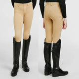Beige whitaker b193 brightside kids jodhpurs with fitted design and belt loops paired with black leather boots