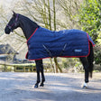 Navy blue quilted whitaker r450 rastrick v2 100g stable rug with red trim belly surcingles and whisker logo