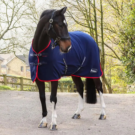 Navy blue whitaker rastrick fleece horse rug v2 with red trim black buckles and branded logo on the side