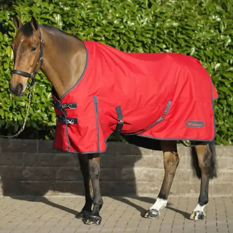Red whitaker rastrick turnout rug with black trim and adjustable straps made from durable fabric for classic style and warmth