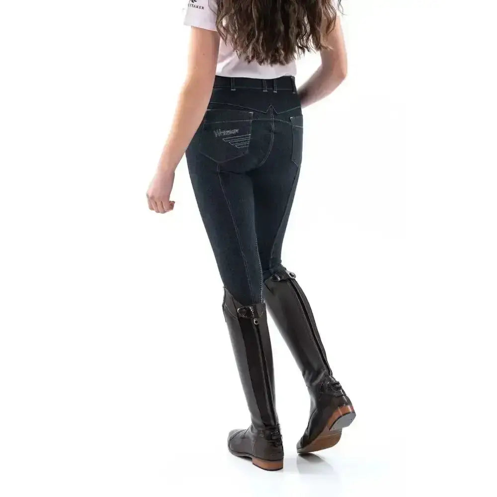 Back view of dark blue whitaker rawdon denim knit breech with subtle embroidered logo on the back pocket