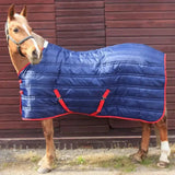 Blue quilted whitaker thomas stable rug 250gm with red trim and straps perfect for stable use