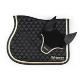 Black quilted horse saddle pad with gold trim and whitaker thornton fly black ear cover featuring whitaker logo