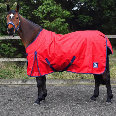 Red turnout rug with navy blue trim and straps featuring a small logo patch on the side perfect for horses