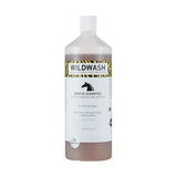A clear plastic bottle of wildwash horse shampoo gentle with evening primrose oil and marshmallow root contains brown liquid