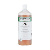 A clear plastic bottle of wildwash horse shampoo medicated with white cap and amber liquid inside