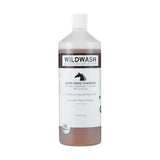 A clear plastic bottle of wildwash horse shampoo ultra shine with white cap and brown liquid for natural coat colour