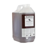 A translucent brown plastic jug with a white cap and handle labeled wildwash horse shampoo ultra shine shampoo for natural coat colour