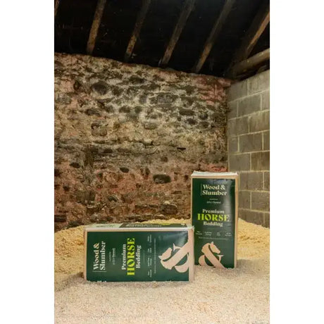 Green and white packaged wood and slumber small flake shavings horse bedding mix in a rectangular bag