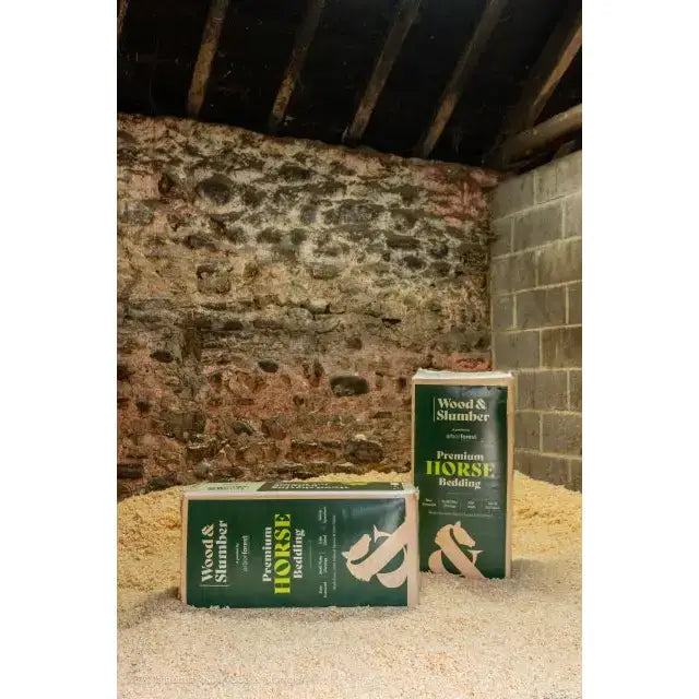 Green and white packaged wood and slumber small flake shavings horse bedding mix in a rectangular bag