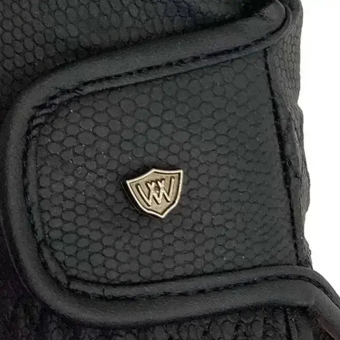 Black textured leather back of woof wear competition glove with metallic shield logo delivering grip and style