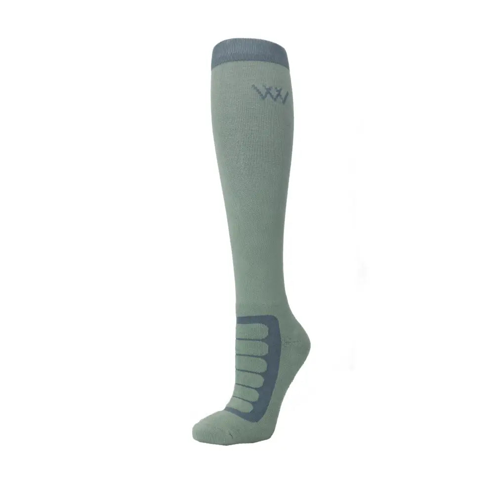 Light green woof wear long bamboo tech riding sock with dark gray arch and heel reinforcement and subtle logo near top