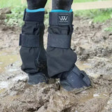 Black woof wear mud fever turnout boots with teal trim and adjustable straps for horse leg protection