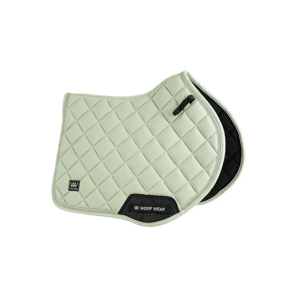 Light green quilted woof wear vision aura close contact saddle pad with black trim and logo patch
