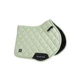 Light green quilted woof wear vision aura close contact saddle pad with black trim and logo patch