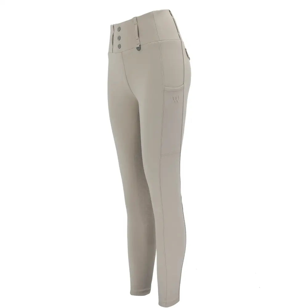 Cream-colored woof wear vision riding tights with high waist button closure and micro-grip silicone detail