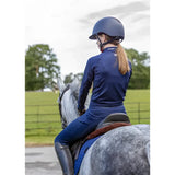 Blue riding helmet with black visor and adjustable straps paired with woof wear young rider tech shirt in iflex fabric