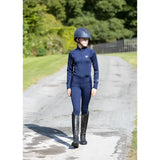 Navy blue woof wear young rider tech shirt made with iflex fabric paired with matching helmet and tall black boots