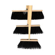 Set of three yard broom nylon bristles flick brush with black bristles and light wood handles like a traditional stable broom