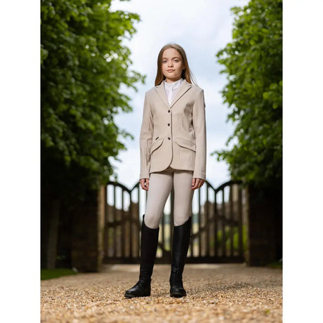 Beige lemieux young rider kennedy equestrian show jacket with three black buttons and flap pockets for horses