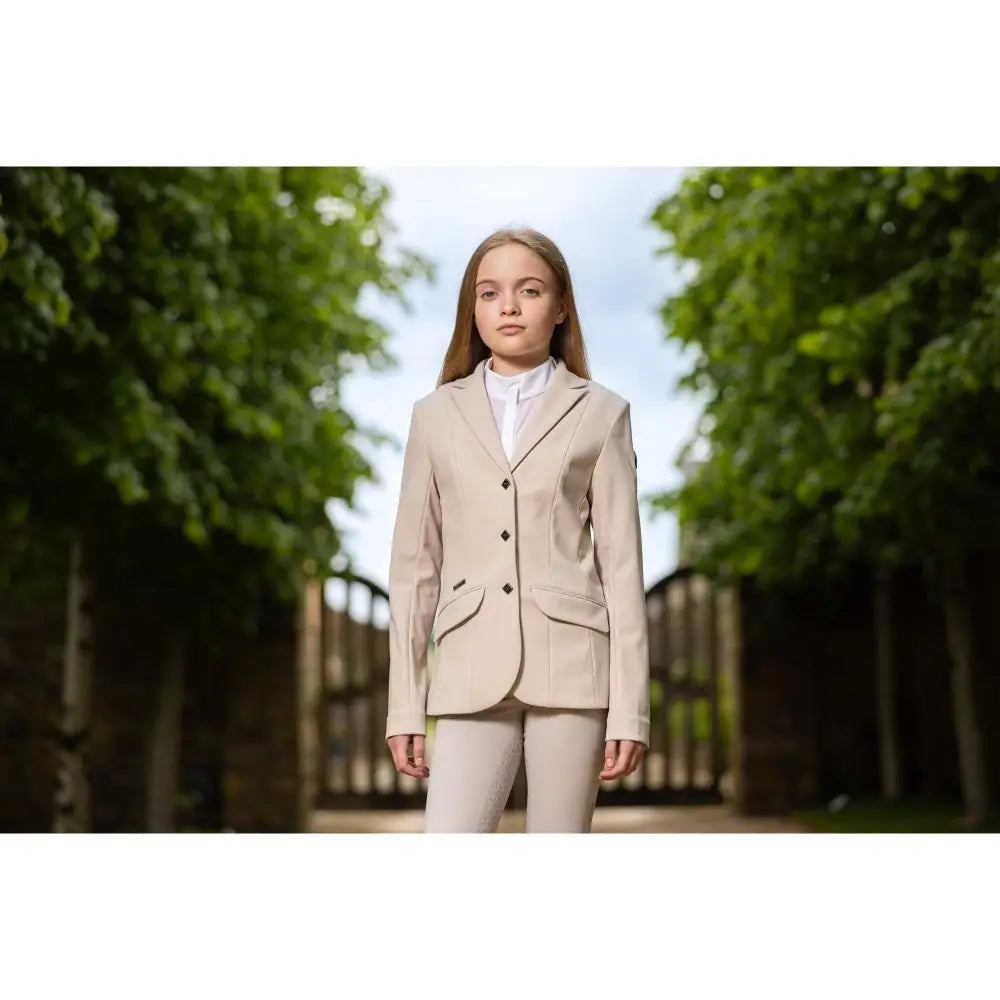 Beige lemieux young rider kennedy show jacket with black buttons and flap pockets perfect for equestrian horses